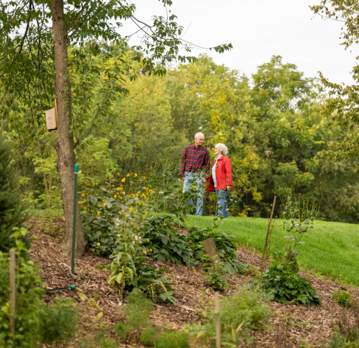 A couple walking on the nature trail at Woodcrest Villa