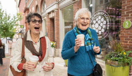 Woodcrest Villa residents drinking coffee while walking in downtown Lancaster