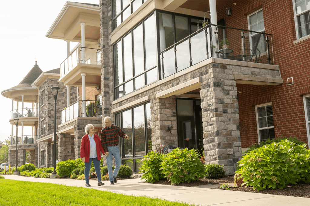 Older couple walking on a sidewalk during a senior living open house