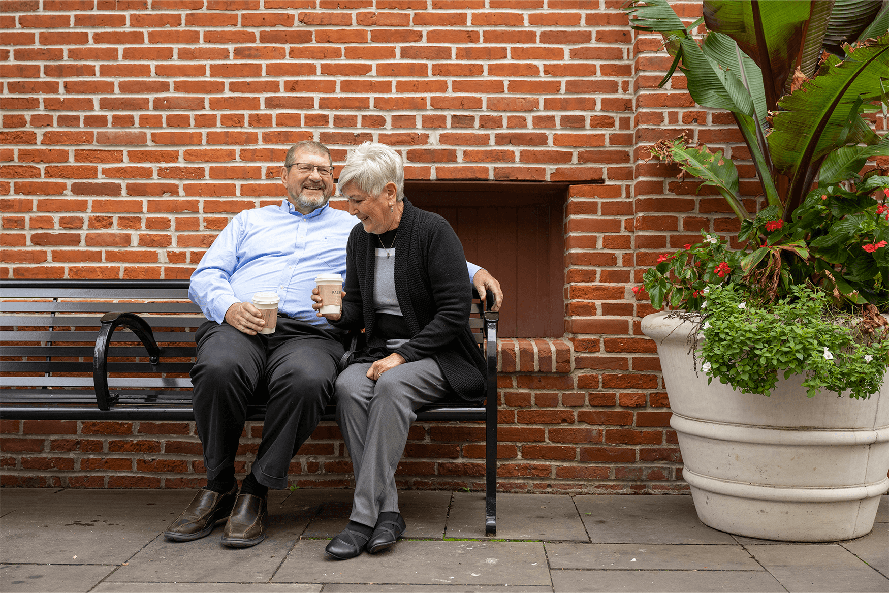 Residents of a senior living community near Willow Street, PA laugh on a bench