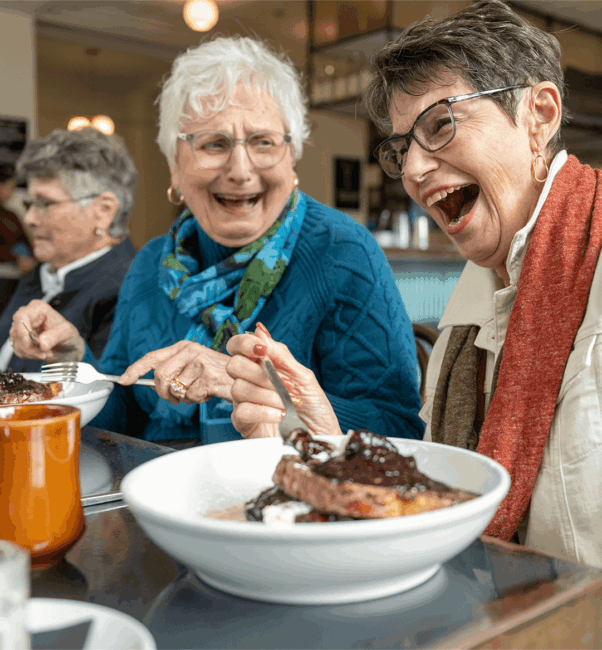 Residents of a senior living community near Willow Street, PA laugh as they eat dinner