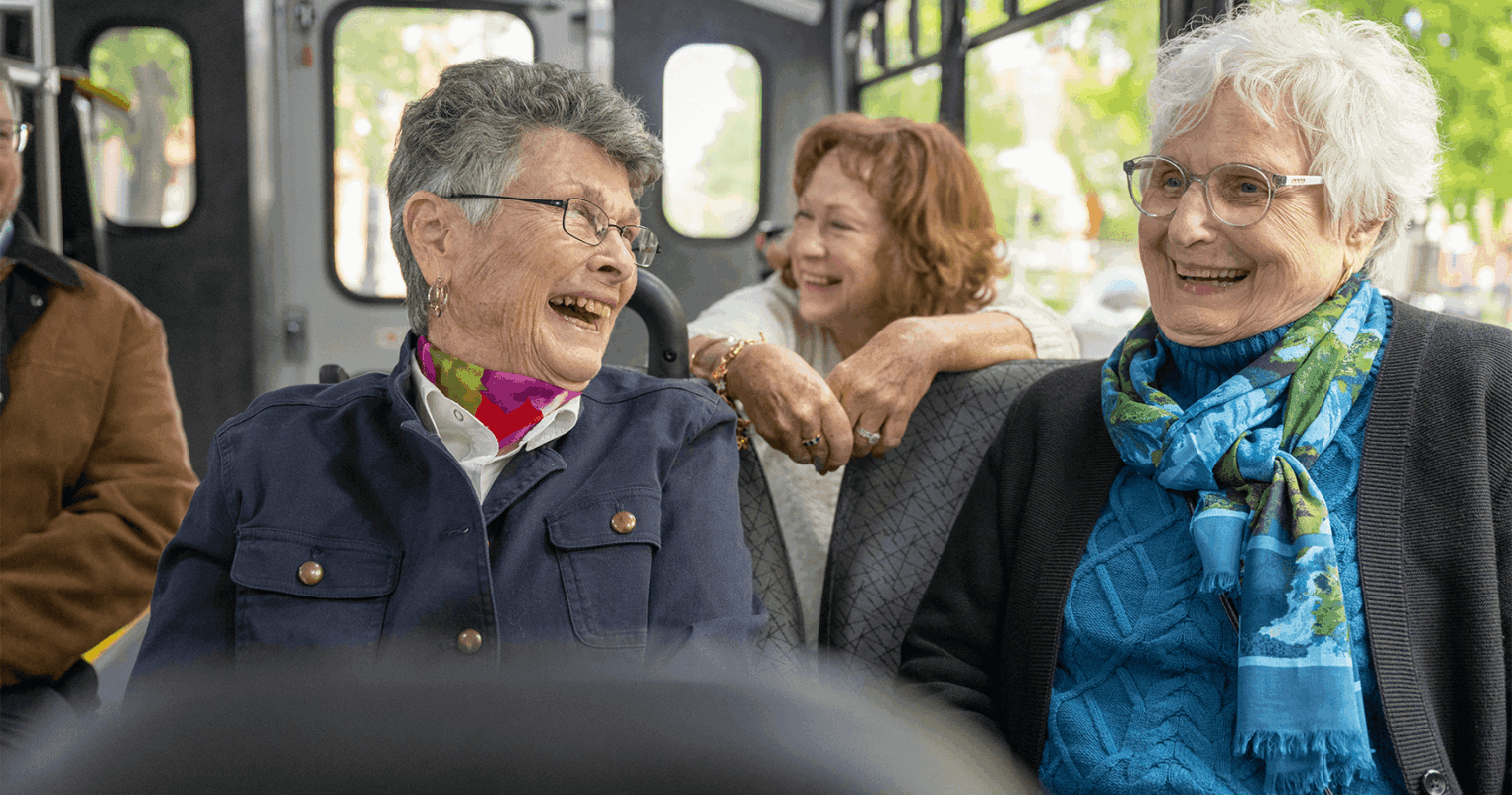 Residents laugh in a car as they travel back to their senior living campus near Willow Street, PA