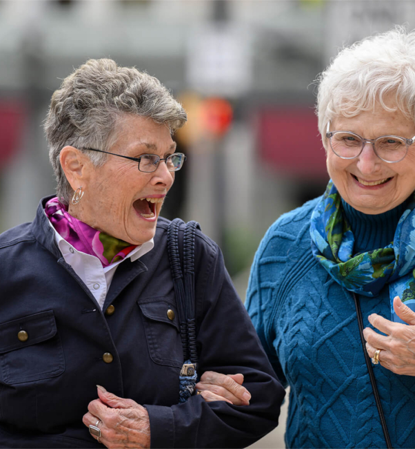 Two elderly women laugh in the street of the best CCRC in Lancaster, PA