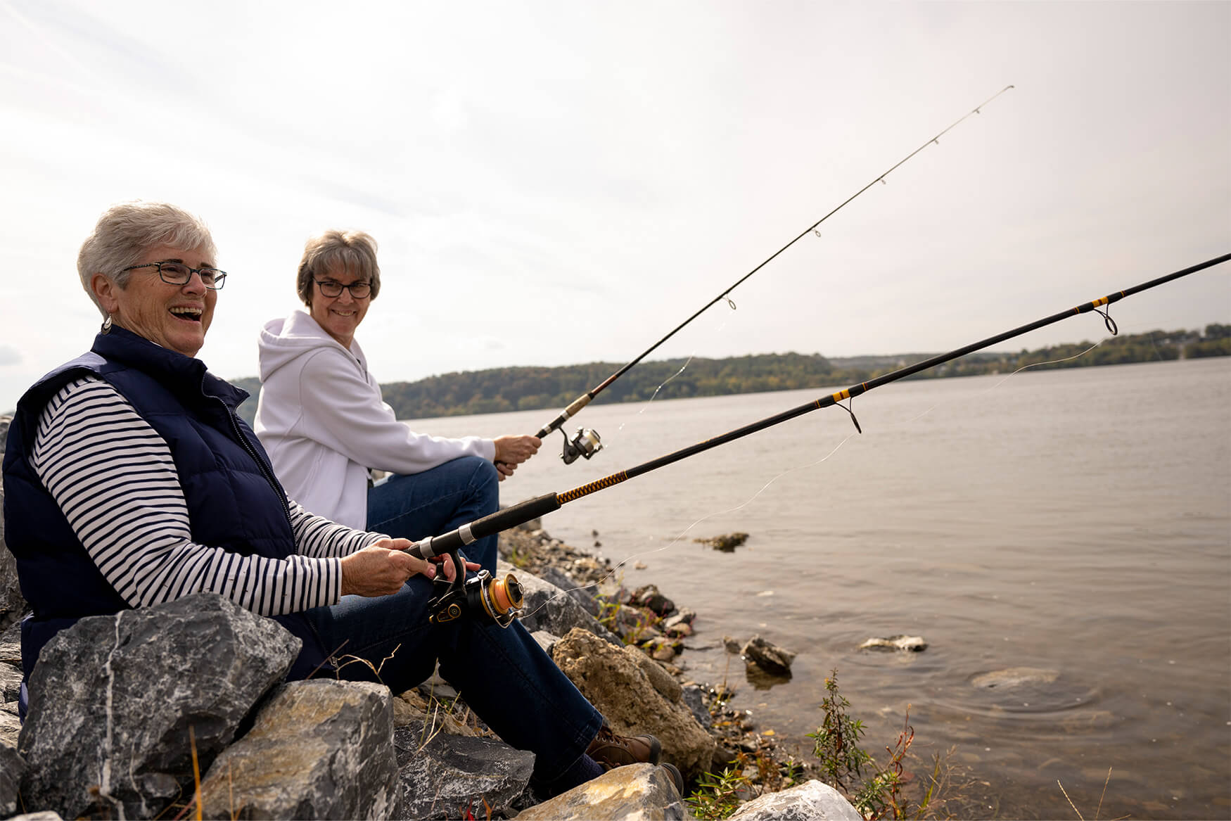 Two residents of senior living near Ephrata, PA fish at a river
