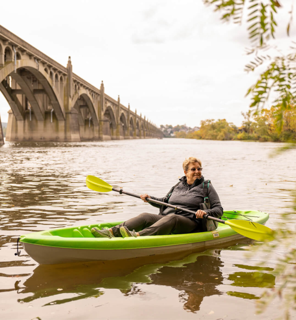 A resident of the Bloom Wellness Woodcrest Villa program kayaks in the fall