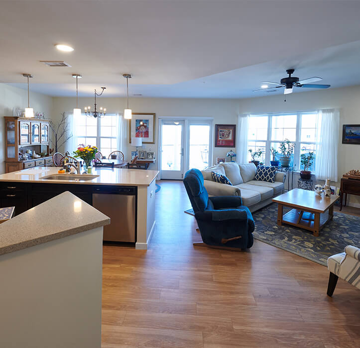 2-bedroom apartment with a den with a large kitchen island and an open living area
