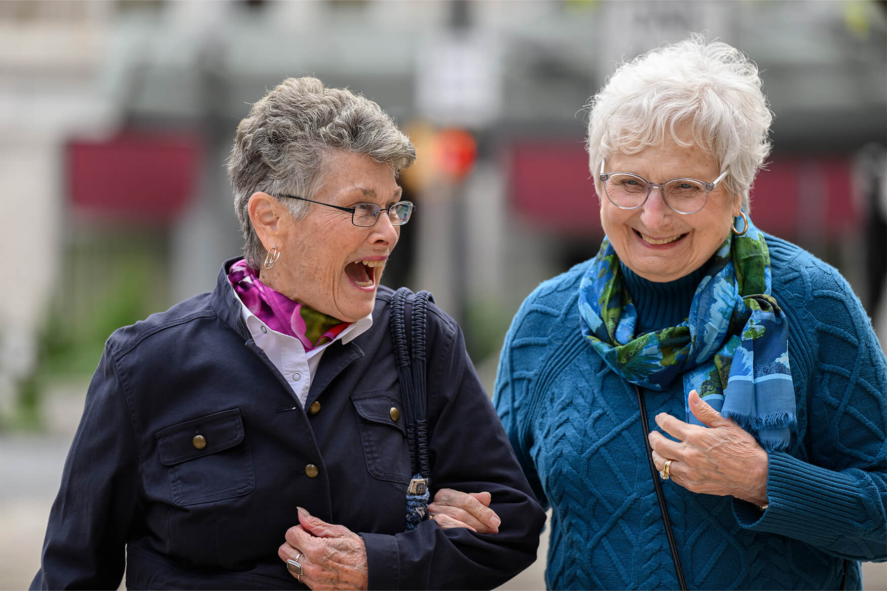 Two residents of a retirement community walk around the city, enjoying senior living near Lititz PA